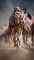 Soldier in dusty terrain carries American flags during a military march at sunrise photo