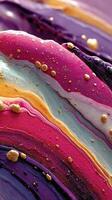 Swirling colors create an abstract artwork with vibrant hues and golden accents on a smooth surface photo