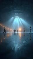 Creative team at work in a large studio with dramatic lighting and reflections on the floor photo