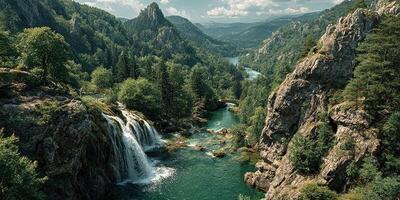 Scenic view of a waterfall cascading into a serene river surrounded by mountains and lush greenery during daylight hours photo
