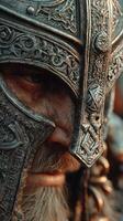 Detailed metal helmet worn by a warrior emphasizing historical craftsmanship and facial expression on a rugged landscape backdrop photo
