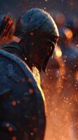 Historic warrior clad in armor stands amidst glowing embers during a heated battle scene at sunset photo