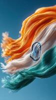 Beautifully flowing Indian flag showcasing vibrant colors against a clear blue sky during a sunny day photo