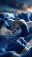 Textile pattern features blue and white waves resembling a flag in a soft, textured setting photo