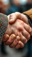 Handshake symbolizing partnership and agreement during an outdoor gathering in the afternoon photo
