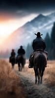 Cowboys riding horses at sunset in a mountainous landscape with beautiful lighting effects photo
