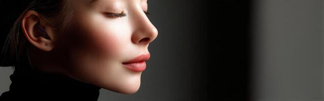 Profile of a woman with closed eyes in soft light setting photo