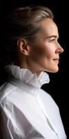 Professional profile portrait of a smiling woman in a white blouse photo