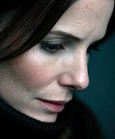 Close-up portrait of a woman with striking features and deep expression photo