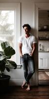 Casual moment in a cozy kitchen with a young man by the window photo