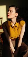 Model poses gracefully in warm sunlight with vintage styling and elegance photo