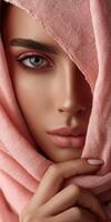 Woman in pink scarf showing elegance and grace with captivating gaze photo
