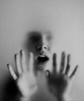 Expression of vulnerability through a blurred figure against a foggy background photo
