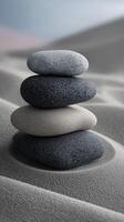 Stacked stones create a balanced composition in soft sand texture photo