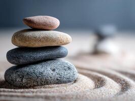 Balanced stones arranged gracefully on smooth sand surface at zen garden photo
