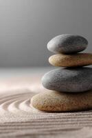 Serene stone stacking in a zen garden with rippled sand patterns photo