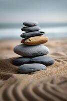 Balanced stones create a tranquil sculpture on the sandy beach photo