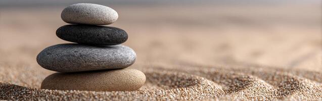 Balanced stones arranged in a calming pattern on sandy surface photo