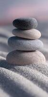 Building a tranquil stone tower on a sandy beach at sunset photo