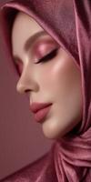 Elegant woman in hijab with soft pink makeup against a pastel background photo