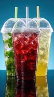 Refreshing cold beverages in colorful cups on a glossy surface photo