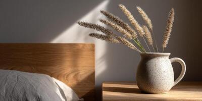 decorativo florero con seco pastos metido en un de madera cabecera mesa foto
