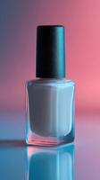 Nail polish bottle with glossy finish against colorful gradient background photo