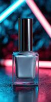 Elegant silver nail polish bottle illuminated by vibrant neon lights photo