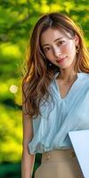 Young woman smiling outdoors in natural light with greenery in background photo