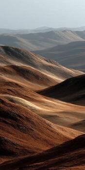Rolling Hills of brown Earth in a Mountain Range photo