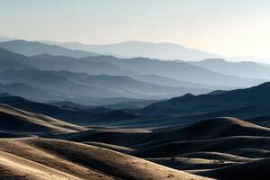 Distant mountains and rolling hills in morning sunlight photo