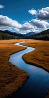 Serene winding river flows through golden valley amidst mountains photo