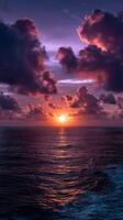Vibrant sunset casts colorful reflections over calm ocean waves photo