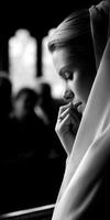 Pensive bride wearing veil in church before ceremony photo