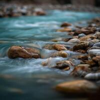 River flows around smooth rocks in nature during a daytime walk photo