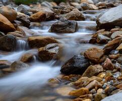 Water flows swiftly through rock formations in the Mountains photo