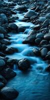 River flowing between rocks during twilight in rocky mountains photo