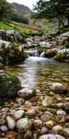 Peaceful river cascades through stony terrain in the Lake District photo