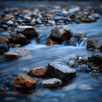 Water flows over rocks in a peaceful river stream photo