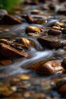 Water flows around rocks in peaceful mountain stream photo