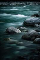 River runs through rocks, long exposure on a winter day photo