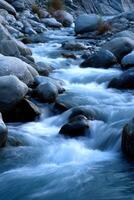 Water flowing over rocks in remote mountain creek photo