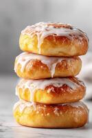 Stack of fresh baked glazed doughnuts on white background photo