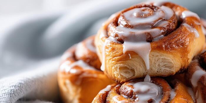 Stack of delicious cinnamon rolls with cream cheese icing photo