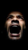 Man's anguished scream in stark shadow and strong emotions photo