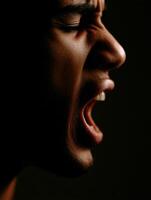 Intense portrait shows man yelling in strong emotion photo
