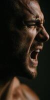 Angered man yelling intensely with his eyes closed tight photo