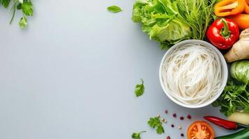 Asian noodles with vegetables are displayed. Cooking recipe in the background is possible photo