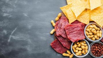 Assorted snacks for event on gray backdrop. Food and drink at gathering. Background for menu photo