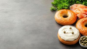 Bagel with cream cheese, salmon, and capers on a table, top view for breakfast or brunch photo
